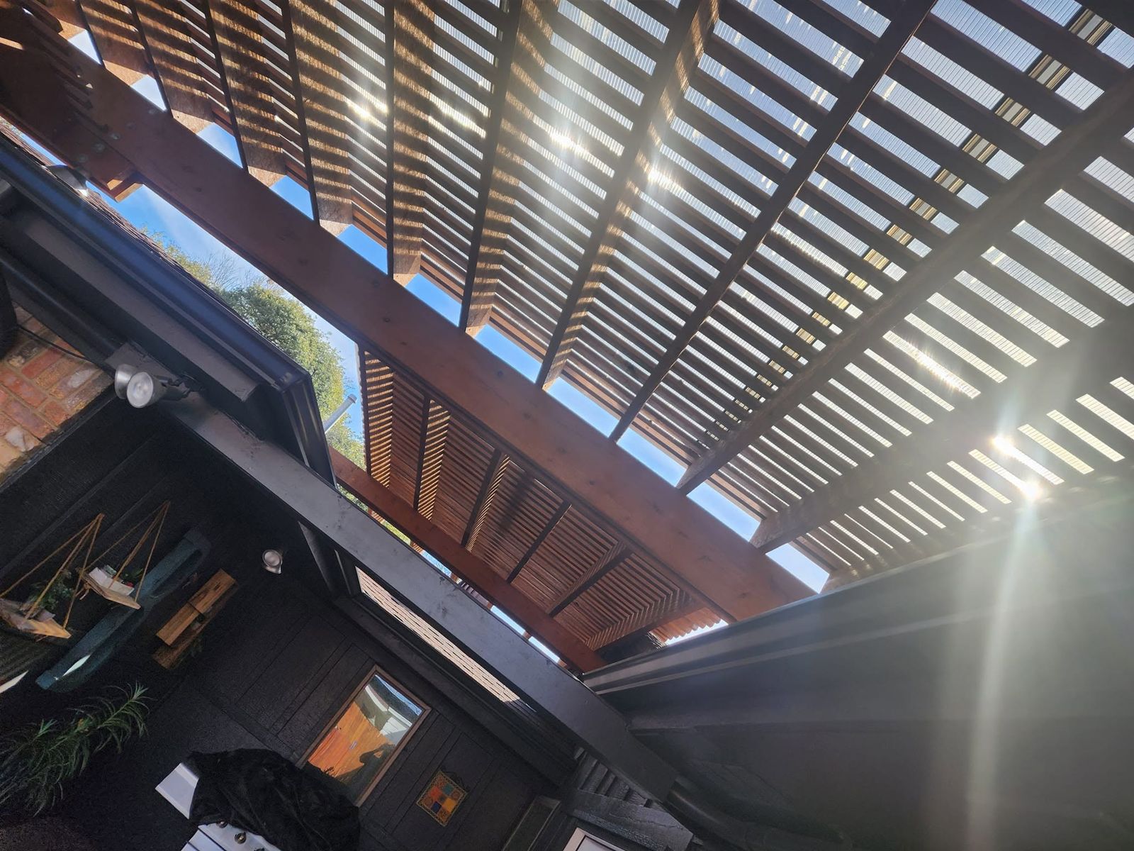 Looking up through a wood louvered patio cover ceiling