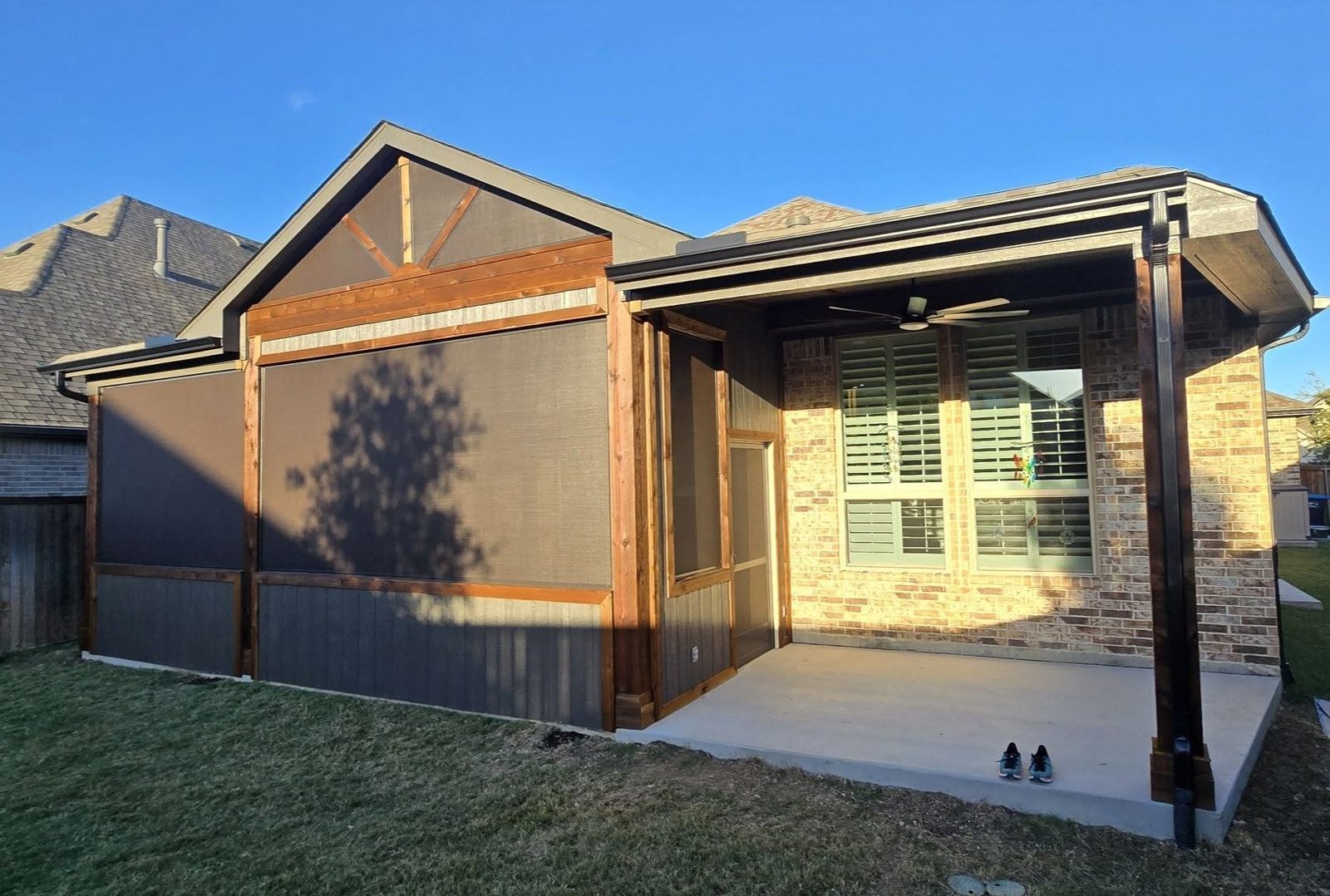 Screened patio enclosure with cedar posts and solar screens