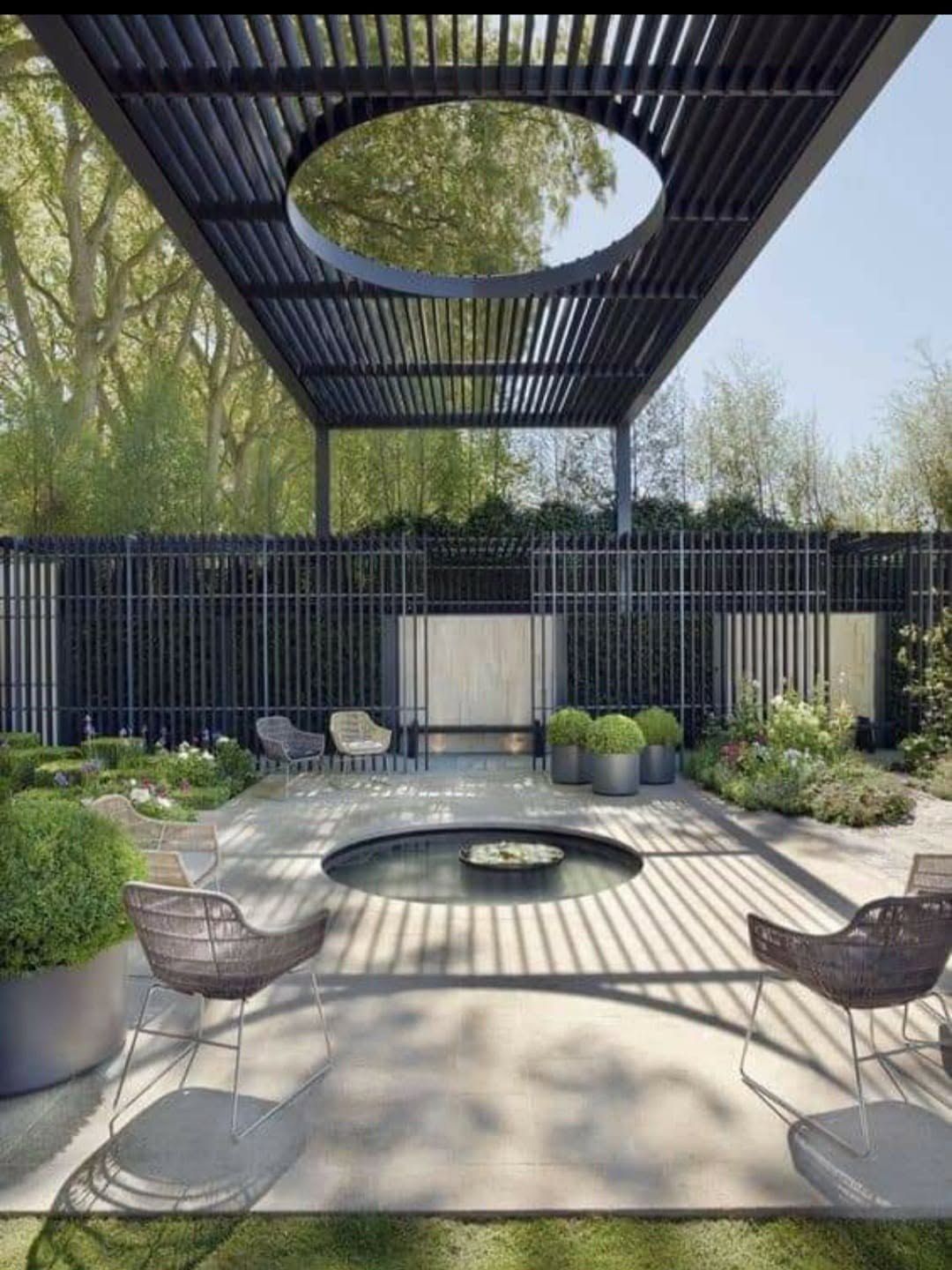Modern louvered pergola over a fire pit and seating area