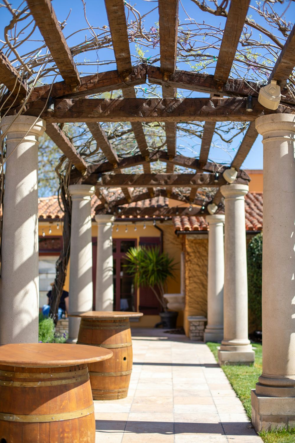 Pergola with stone columns and climbing vines