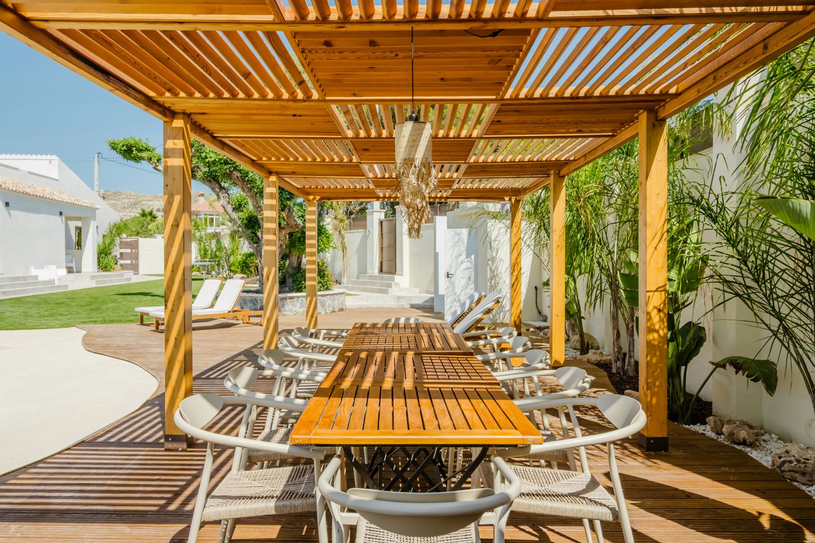 Large wood pergola over an outdoor dining table